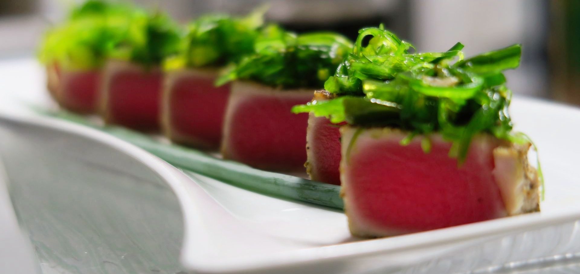 Sliced sesame seared tuna topped with seaweed salad. A Destination Catering & Events beloved Hors D'oeuvre for cocktail parties. 