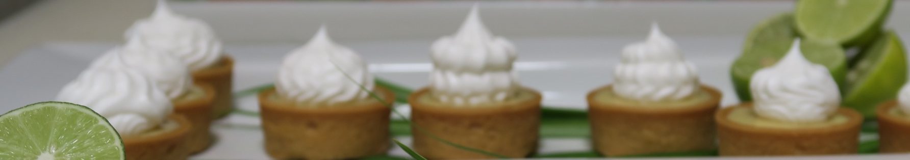 Key-Lime Tartlets Mini tartlets topped with whipped cream and garnished with mint leaves.