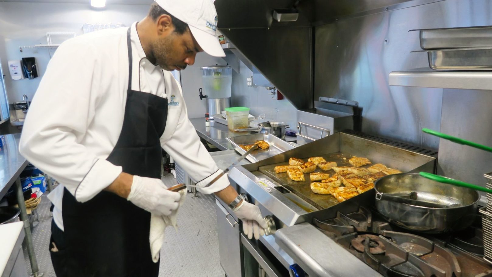 Chef T. working the Mango Mahi on the Grill. Destination Catering & Events' Chef T. showing off his skills on the grill.